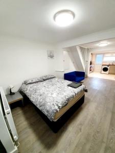 a bedroom with a large bed and a staircase at Chelmsford Town Centre New Modern Apartments in Chelmsford
