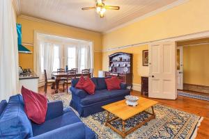 a living room with a blue couch and a table at Fernando's self catering cottages in Port Elizabeth
