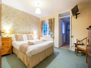A bed or beds in a room at Wincham Hall Hotel