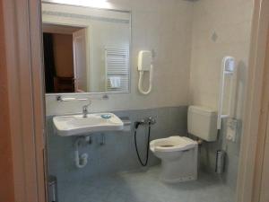 a bathroom with a sink and a toilet and a mirror at Gran Osteria Tre Noci in Sistiana