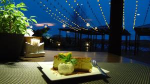 a piece of cake on a plate on a table at Villa Alicante & SPA in Zujūnai