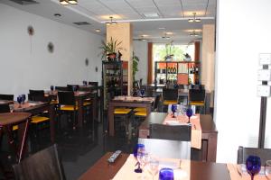 a restaurant with tables and chairs with wine glasses on them at Hotel Ciutat d'Amposta in Amposta