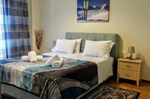 a bedroom with a large bed with white pillows at Delphic Horizons in Delphi
