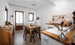 a kitchen with a table and a small kitchen with a counter at Al vicolo del Gallo APPARTAMENTO in Varallo