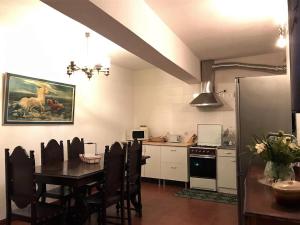 a kitchen with a table and a dining room at Casa da Escola Antiga in Manteigas
