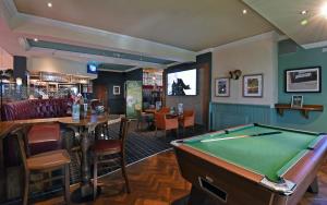 a pub with a pool table and a bar at Lea Gate by Greene King Inns in Preston