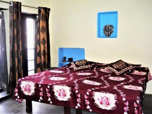 a bedroom with a bed with a purple comforter at Shiva lodge in Varanasi
