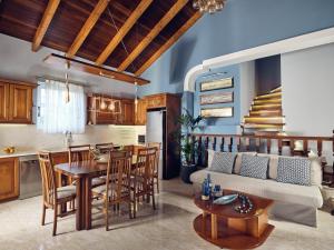 a kitchen and living room with a couch and a table at Villa Castelletto heated pool jacuzzi in Kipseli