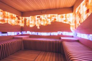 a sauna with red benches and a wooden ceiling at Iberostar Waves Slavija in Budva