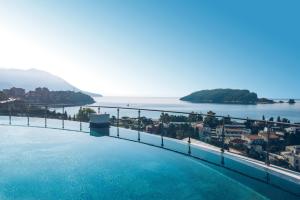 a swimming pool with a view of the water at Iberostar Waves Slavija in Budva