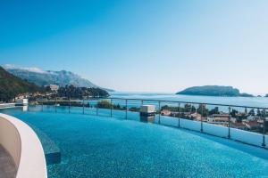 a swimming pool with a view of the ocean at Iberostar Waves Slavija in Budva
