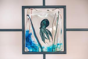a picture of a mermaid in a glass frame at Iberostar Waves Slavija in Budva