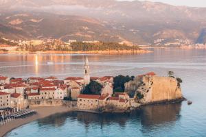 an island in the middle of a body of water at Iberostar Waves Slavija in Budva