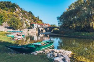 a group of boats on a river with a bridge at Iberostar Waves Slavija in Budva