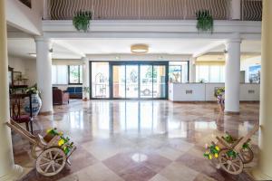 a large room with a lobby with two strollers at Delfino Beach Hotel in Marsala