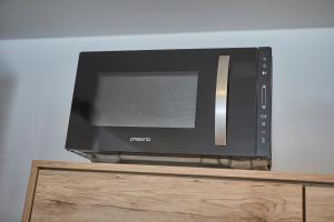 A television and/or entertainment centre at Glemm Lodge Apartments - JOKER CARD im Sommer inklusive