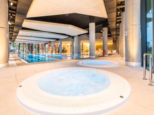 a large pool in a building with a swimming pool at 3L Apartments Seaside Park in Kołobrzeg