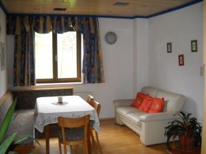 a living room with a table and a couch at Bauernhof Marx in Gaal