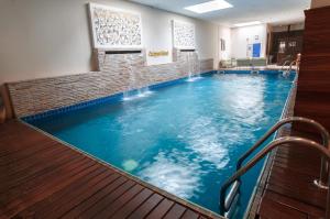 a large swimming pool in a hotel room at Calypso Hôtel in Toamasina