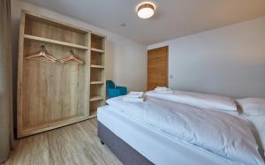 A bed or beds in a room at Glemm Lodge Apartments - JOKER CARD im Sommer inklusive