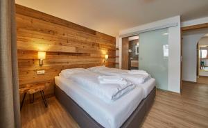 A bed or beds in a room at Glemm Lodge Apartments - JOKER CARD im Sommer inklusive