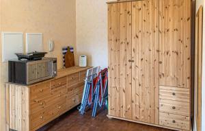 a room with wooden cabinets and a large wooden closet at Pet Friendly Apartment in Gollwitz +8 photos