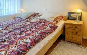 a large bed in a bedroom with a night stand at Pet Friendly Apartment in Gollwitz