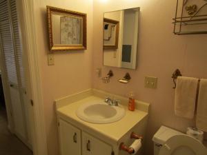 a bathroom with a sink and a toilet and a mirror at Sugar Top 2910 condo in Sugar Mountain +6 photos