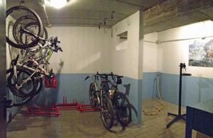 two bikes hanging on a wall in a garage at La Collina dei Fiori in Vercana