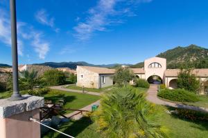 a view of a house with mountains in the background at Alma Resort in Castiadas