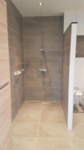 a shower with a glass door in a bathroom at Hoeve Kroonen in Schin op Geul +48 photos