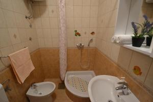 a bathroom with a sink and a shower and a toilet at Apartmani Antonia Nakić -Stobreč in Split +43 photos