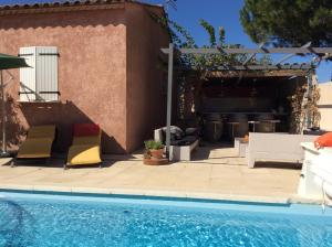 a patio with two chairs and a swimming pool at La Milhaud in Milhaud