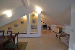 a large living room with a couch and a tv at Apartmani Antonia Nakić -Stobreč in Split