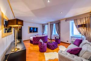 a large living room with purple furniture and windows at Spanish Steps amazing Apartment in Rome