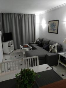 a living room with a couch and a table at Urb. Lubina Sol in Mijas Costa