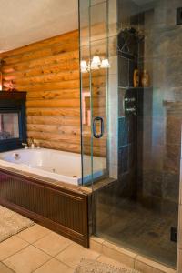 a bathroom with a tub and a glass shower at A Breath of Heaven B&B in Traverse City