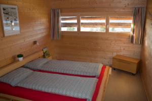a small room with two beds and a window at La Casa Cathomen Brigels - Maiensäss/Berghaus für max. 6 Personen in Breil/Brigels