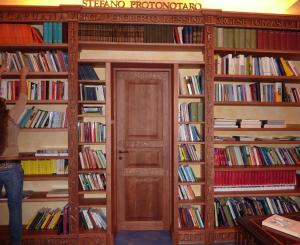 a door in a library filled with books at Hotel Palladio in Giardini Naxos