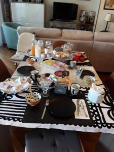 a table with food and plates on top of it at Posada Serena in Bologna