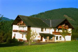 a large white building with a black roof at Bauernhof Marx in Gaal