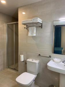 a bathroom with a toilet and a sink and a shower at Solesperit in Lloret de Mar