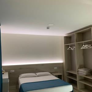 a bedroom with a bed with a light above it at Solesperit in Lloret de Mar