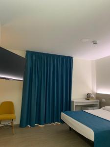 a bedroom with a bed and a blue curtain at Solesperit in Lloret de Mar