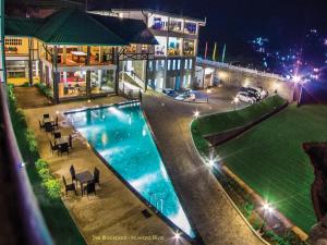 an aerial view of a house with a swimming pool at night at The Blackpool Resort & Spa in Nuwara Eliya