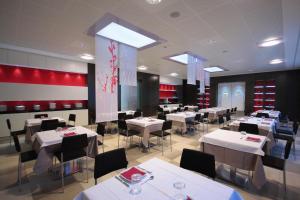 a dining room with white tables and chairs at Hotel Nazionale in Matera +59 photos