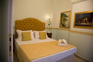 a bedroom with a large bed with a large headboard at B&B Art Suite Santa Brigida in Naples