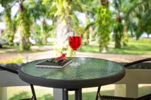 a glass of wine and a book on a table at Green Garden House in Ao Nam Mao +33 photos
