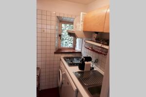 a small kitchen with a stove and a sink at Appartamento Petrarca in Parma +2 photos