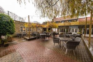 a patio with tables and chairs in front of a building at Cross Keys by Chef & Brewer Collection in Nunthorpe
